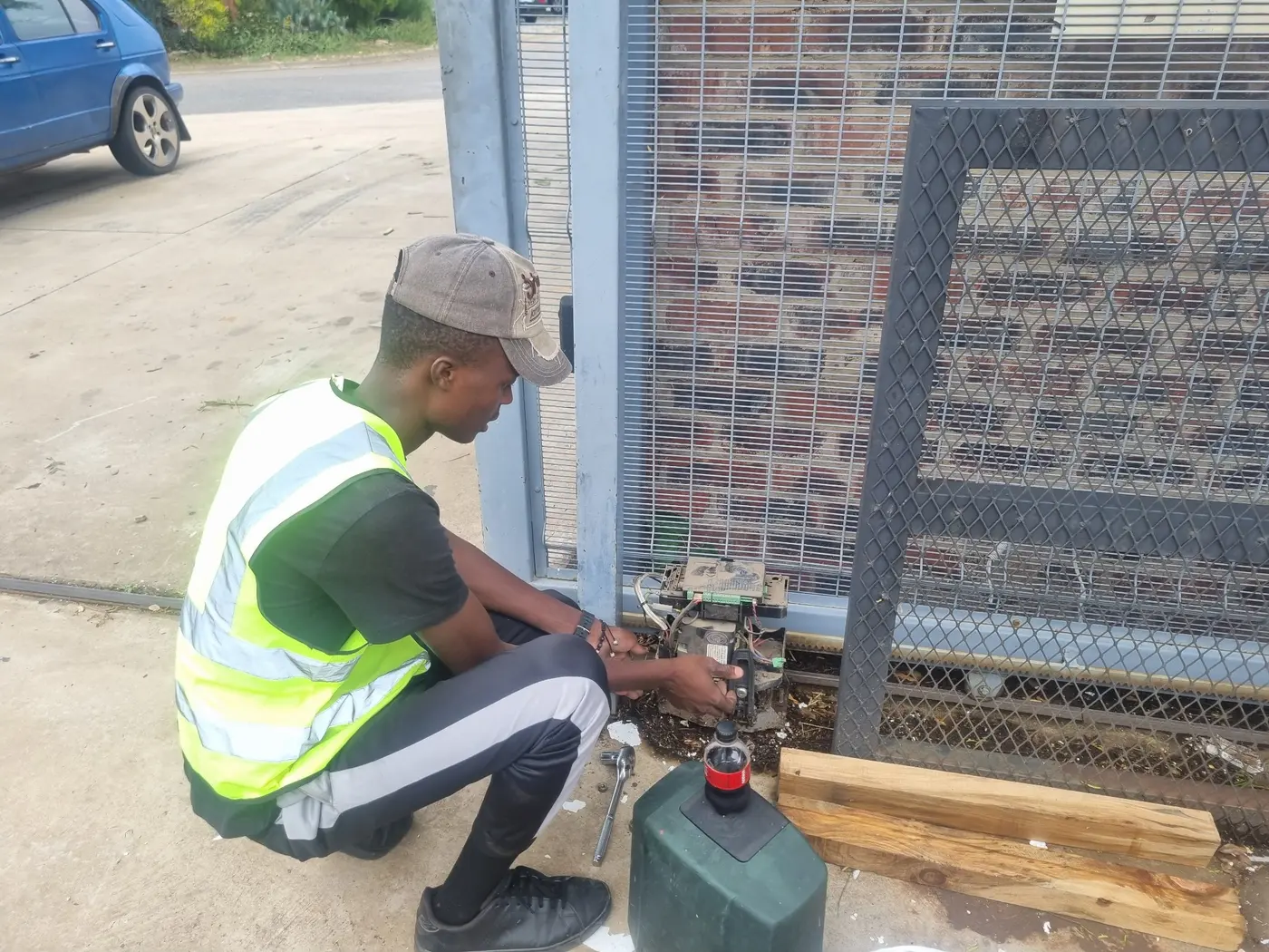 Prime Secure Systems technician repairing a sliding gate motor for Security Systems, Garage Doors &amp; Gate Automation